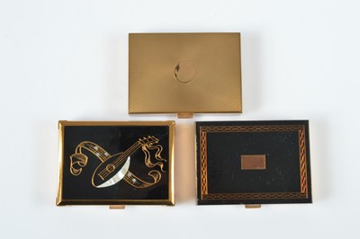 Lot 663 - Three Agme gilt metal rectangular musical compacts