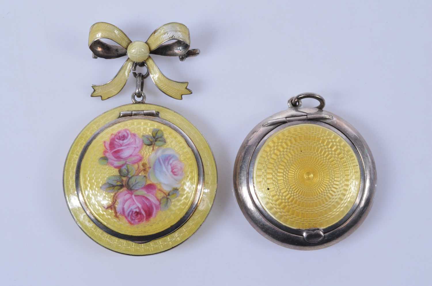 Lot 718 - A yellow guilloche enamel decorated silver brooch or pendant compact
