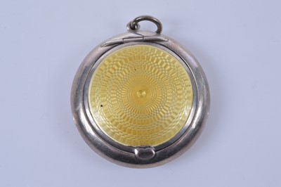Lot 718 - A yellow guilloche enamel decorated silver brooch or pendant compact