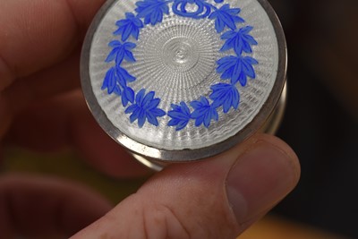 Lot 719 - Three circular silver blue guilloche enamel mounted compacts