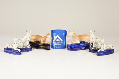 Lot 195 - A pair of antique Staffordshire figural Greyhound pen holders