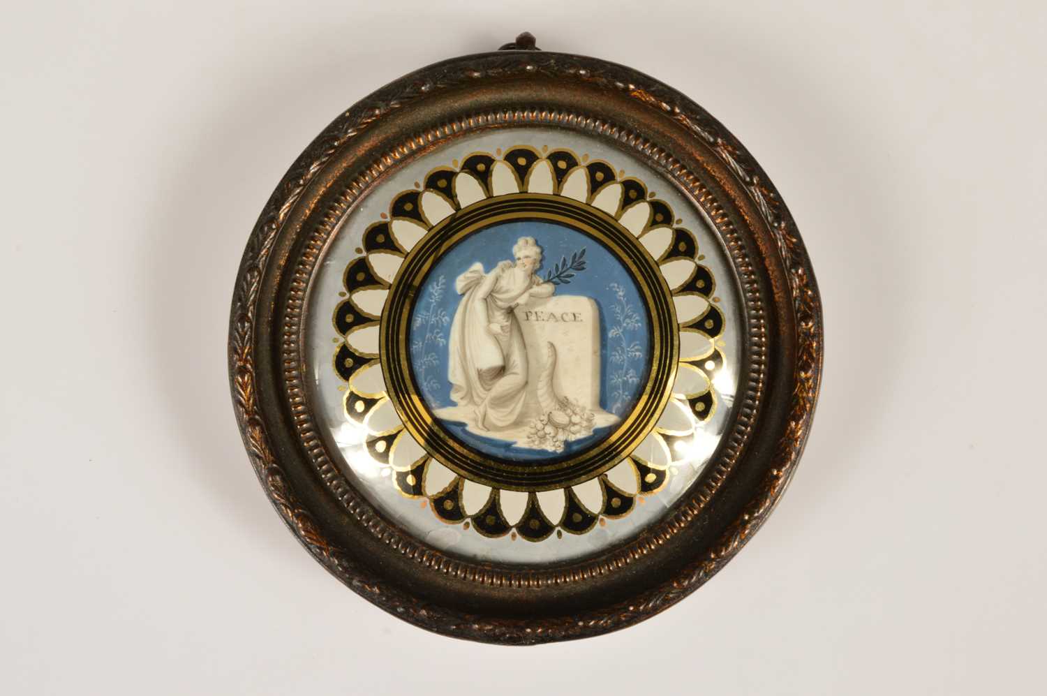 Lot 72 - A George III or Regency Era verre églomisé miniature commemorating "Peace" circa 1814