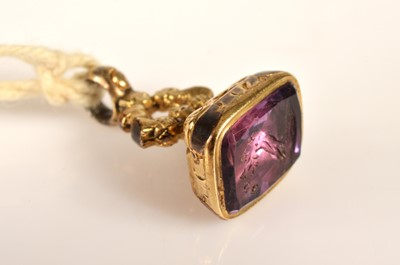 Lot 91 - A pinchbeck seal with a carved amethyst matrix commemorating 'Peace' circa 1814