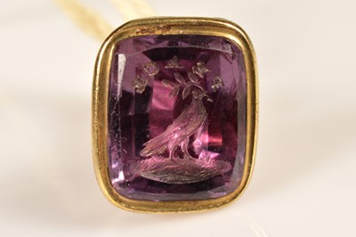 Lot 91 - A pinchbeck seal with a carved amethyst matrix commemorating 'Peace' circa 1814