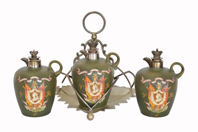 Lot 291 - A plated and ceramic decanter set