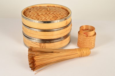 Lot 11 - An Asian two division bamboo and metal banded steamer
