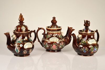 Lot 49 - A set of three bargeware teapots