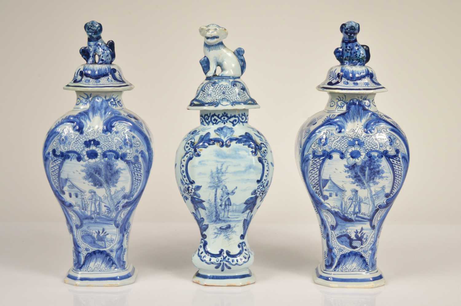 Lot 58 - A pair of Dutch Delft baluster vase and covered
