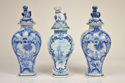 Lot 58 - A pair of Dutch Delft baluster vase and covered
