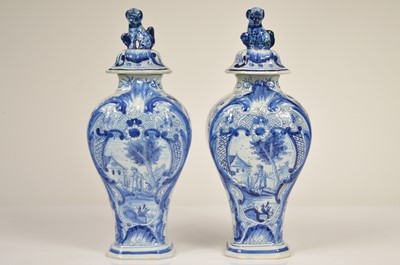 Lot 58 - A pair of Dutch Delft baluster vase and covered