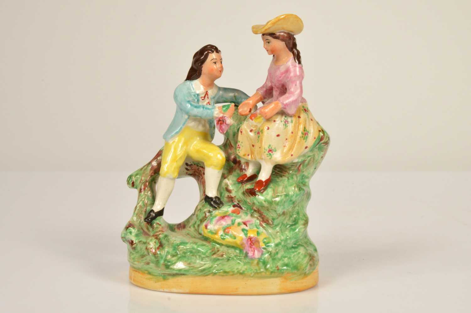 Lot 70 - A 19th century Staffordshire figure of a courting couple