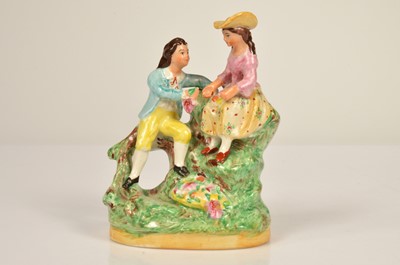 Lot 70 - A 19th century Staffordshire figure of a courting couple