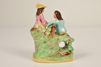Lot 70 - A 19th century Staffordshire figure of a courting couple