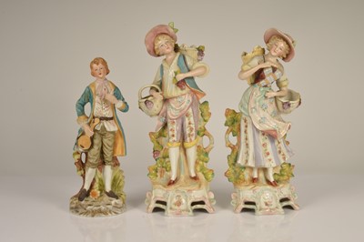 Lot 92 - A pair of continental porcelain figurine of grape pickers
