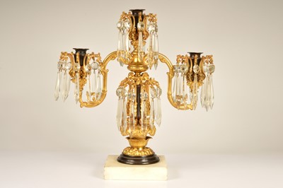 Lot 137 - A late 19th Century or early 20th Century bronzed and gilt metal two branch candelabra