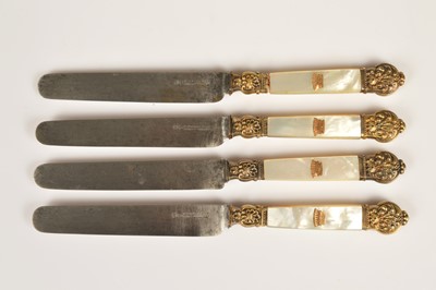 Lot 153 - A set of four continental grange ret steel bladed mother of pearl gilt mounted table knives