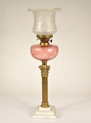 Lot 163 - A marble brass and cranberry glass columned paraffin lamp