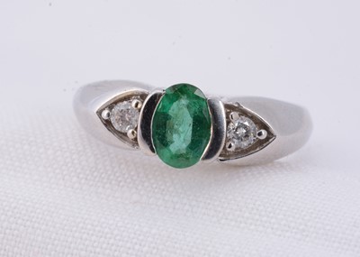Lot 13 - A 9ct gold three stone emerald & diamond dress ring