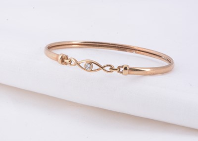 Lot 20 - A 9ct gold diamond set bangle