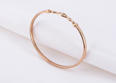 Lot 20 - A 9ct gold diamond set bangle