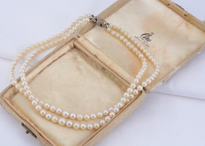 Lot 43 - A graduated double row cultured pearl necklace with 9 ct gold & diamond clasp