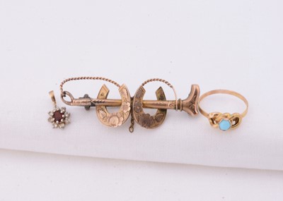 Lot 108 - A yellow metal horseshoe & whip brooch & yellow metal turquoise set knot ring
