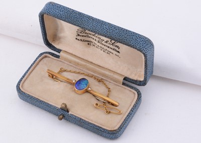 Lot 109 - A 9ct gold black opal set bar brooch