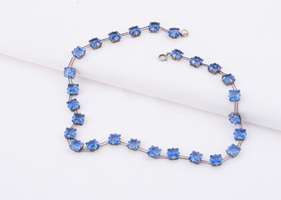 Lot 110 - An Art Deco W. H. Collins & Co sterling silver square blue paste riviere necklace