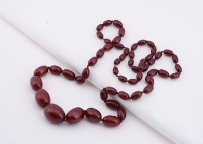 Lot 133 - A strand of Art Deco graduated cherry amber beads