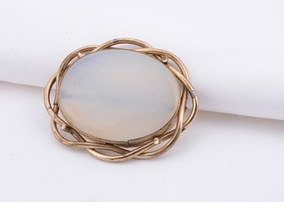 Lot 134 - A pinchbeck agate cabochon brooch, antique pinch beck bevel set brooch with twist detail outer