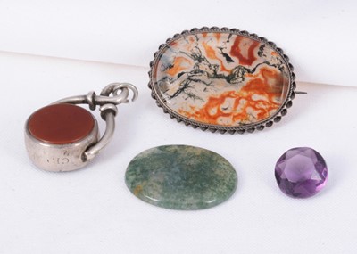 Lot 152 - An antique moss agate silver brooch, a silver hard stone swivel fob & two unmounted stones