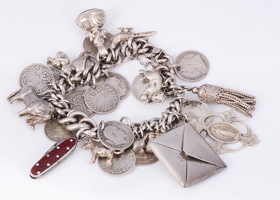 Lot 154 - A silver charm & coin bracelet