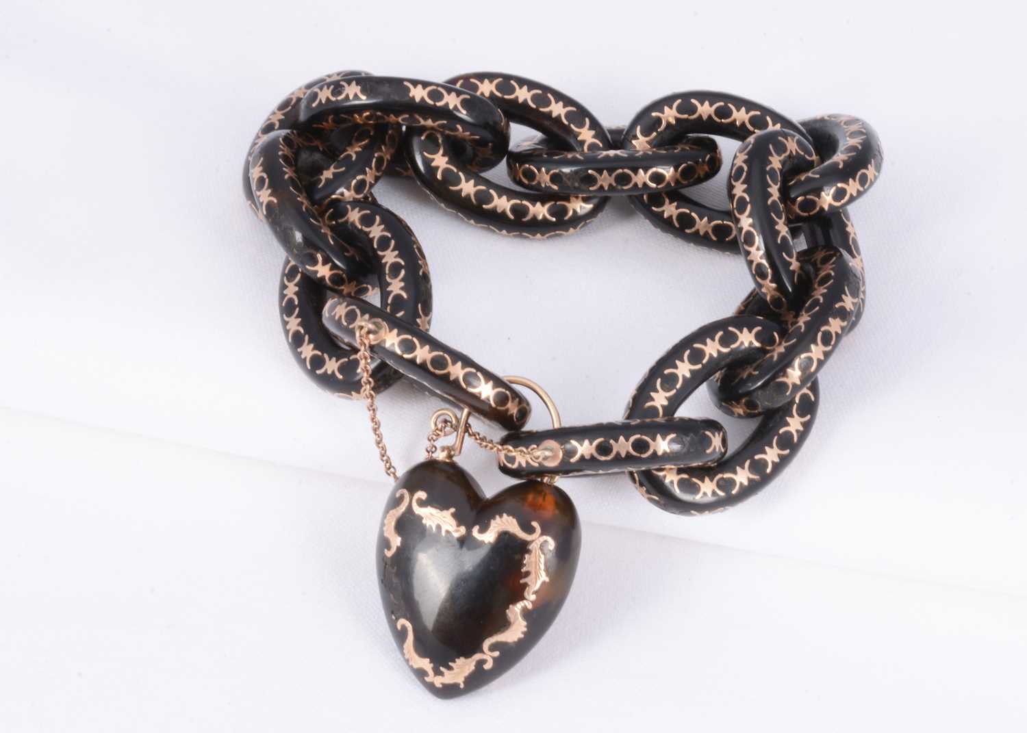 Lot 156 - A 19th century tortoiseshell link & locket bracelet with gold pique work throughout