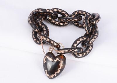 Lot 156 - A 19th century tortoiseshell link & locket bracelet with gold pique work throughout