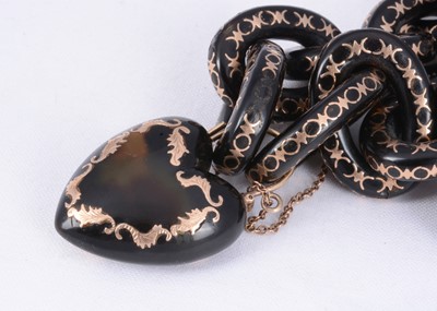 Lot 156 - A 19th century tortoiseshell link & locket bracelet with gold pique work throughout