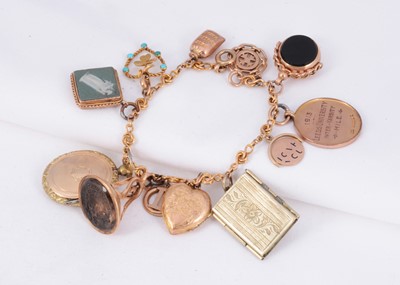 Lot 165 - A 9ct gold charm bracelet with 12 charms