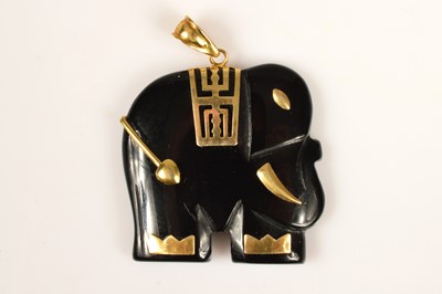 Lot 196 - A black onyx elephant pendant with continental yellow metal detail