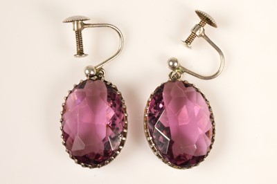 Lot 218 - A pair of silver mounted purple paste earrings