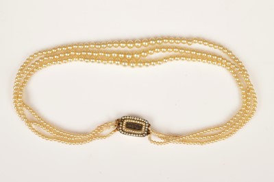 Lot 236 - An antique gold mourning clasp simulated triple row graduated pearl necklace