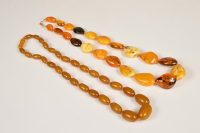 Lot 250 - A string of Baltic & desert amber graduated pebble necklace