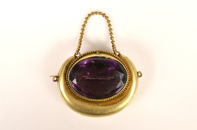 Lot 252 - A late 19th Century continental paste set an gilt metal ovoid brooch, with chain suspension