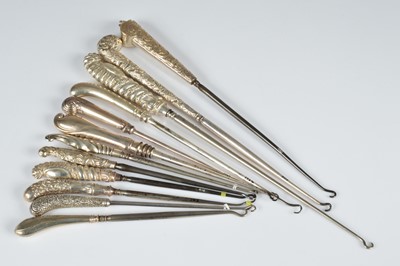 Lot 260 - A collection of twelve silver handled button hooks