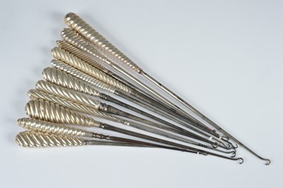 Lot 268 - A collection of eleven silver handled button hooks