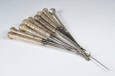 Lot 270 - A collection of nine silver handled button hooks