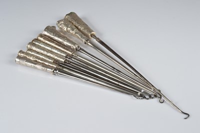 Lot 272 - A collection of nine silver handled button hooks