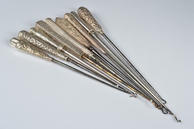 Lot 274 - A collection of nine silver handled button hooks