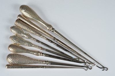 Lot 282 - Eight silver handled button hooks