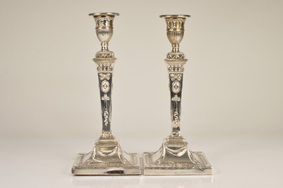 Lot 336 - A pair of late Victorian silver filled candlesticks by Thomas Bradbury & Son