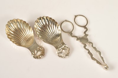 Lot 346 - Two 1970s silver shell shaped tea caddy spoons and a pair of Georgian style sugar tongs