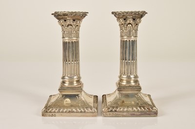 Lot 366 - A pair of Edwardian column silver filled candlesticks by H.E. Ltd